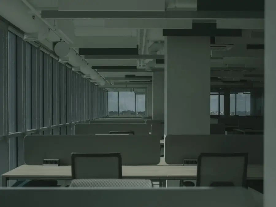 An empty office floor with desks left behind