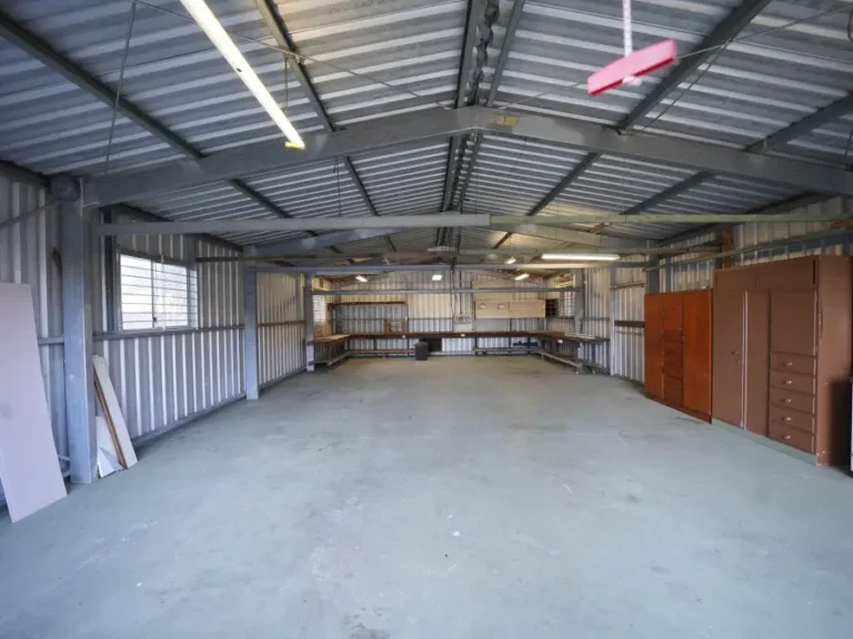 An empty warehouse interior with a bare concrete floor