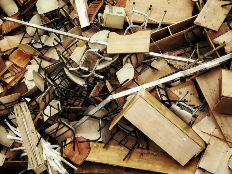 A pile of discarded chairs and table frames