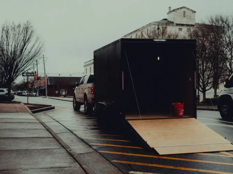 An open trailer parked on a street ready for loading