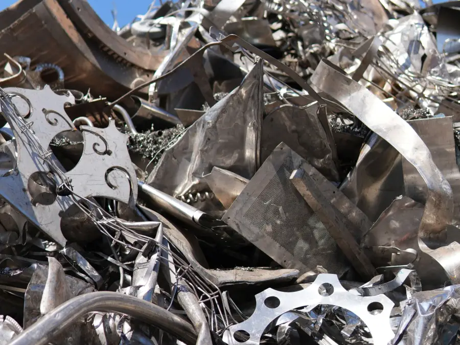Bright cut metal pieces piled under an open sky