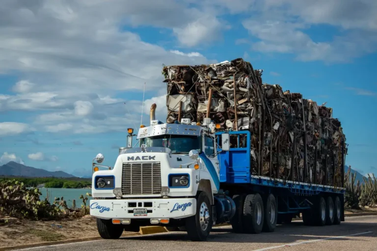 A truck loaded with scrap metal on a rural road