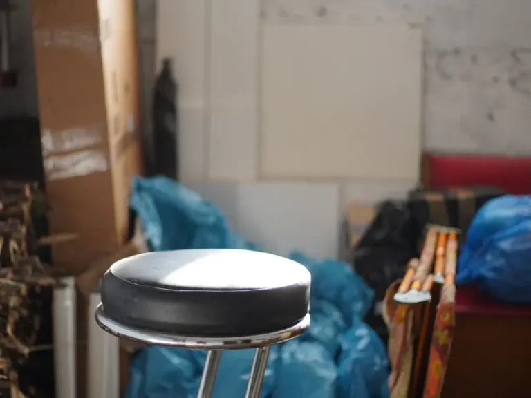A basement corner filled with bags and discarded household items